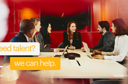 a group of people in a meeting with text to the left saying need talent? we can help.