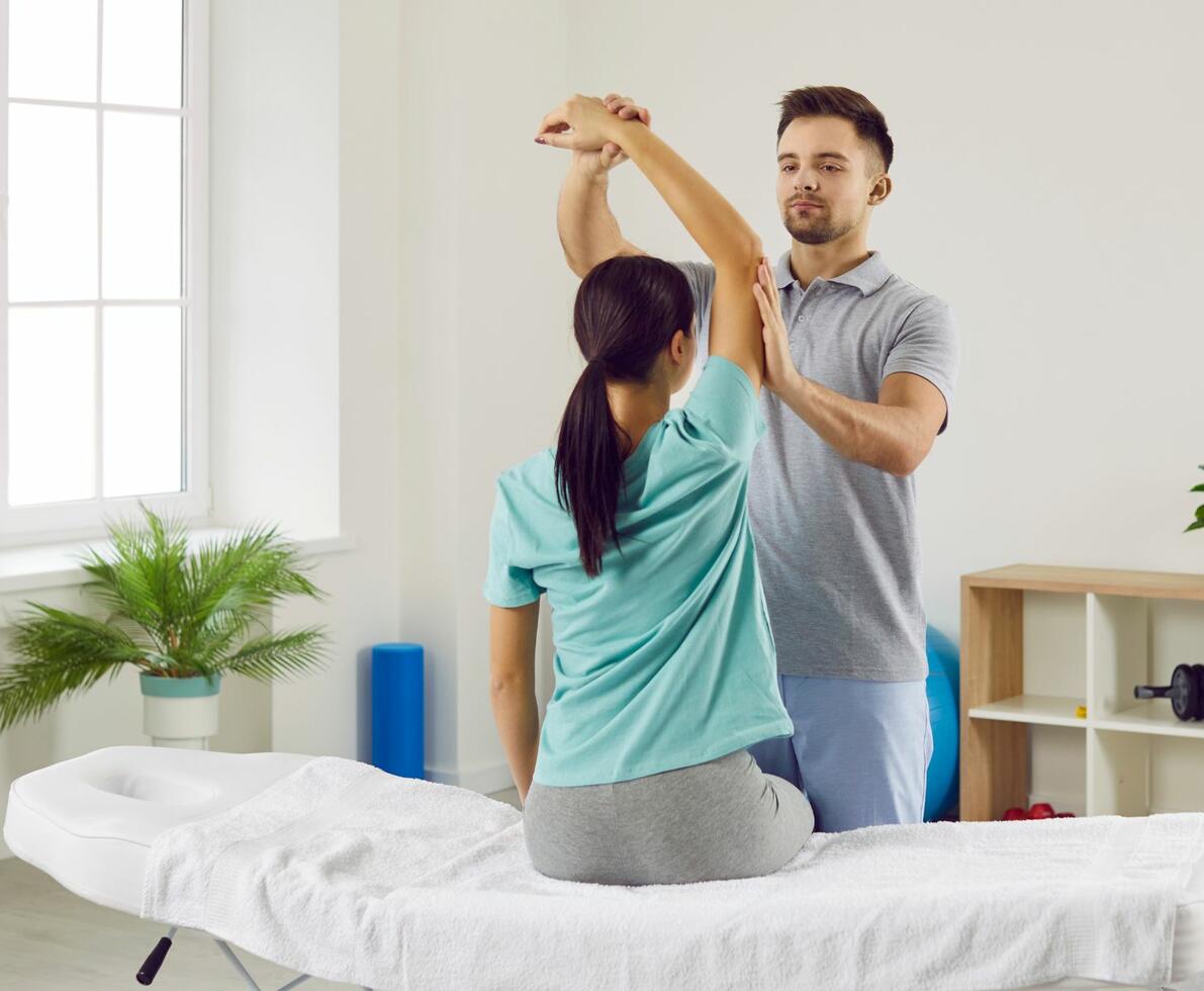 image of a physiotherapist examining his patient's upper arm
