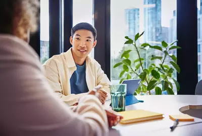 Male and female talking at a table