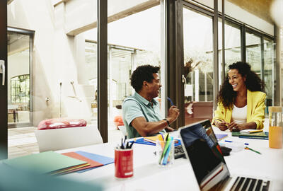 male and female having a laugh during a meeting in a meeting room.
 male and female having a laugh during a meeting in a meeting room.