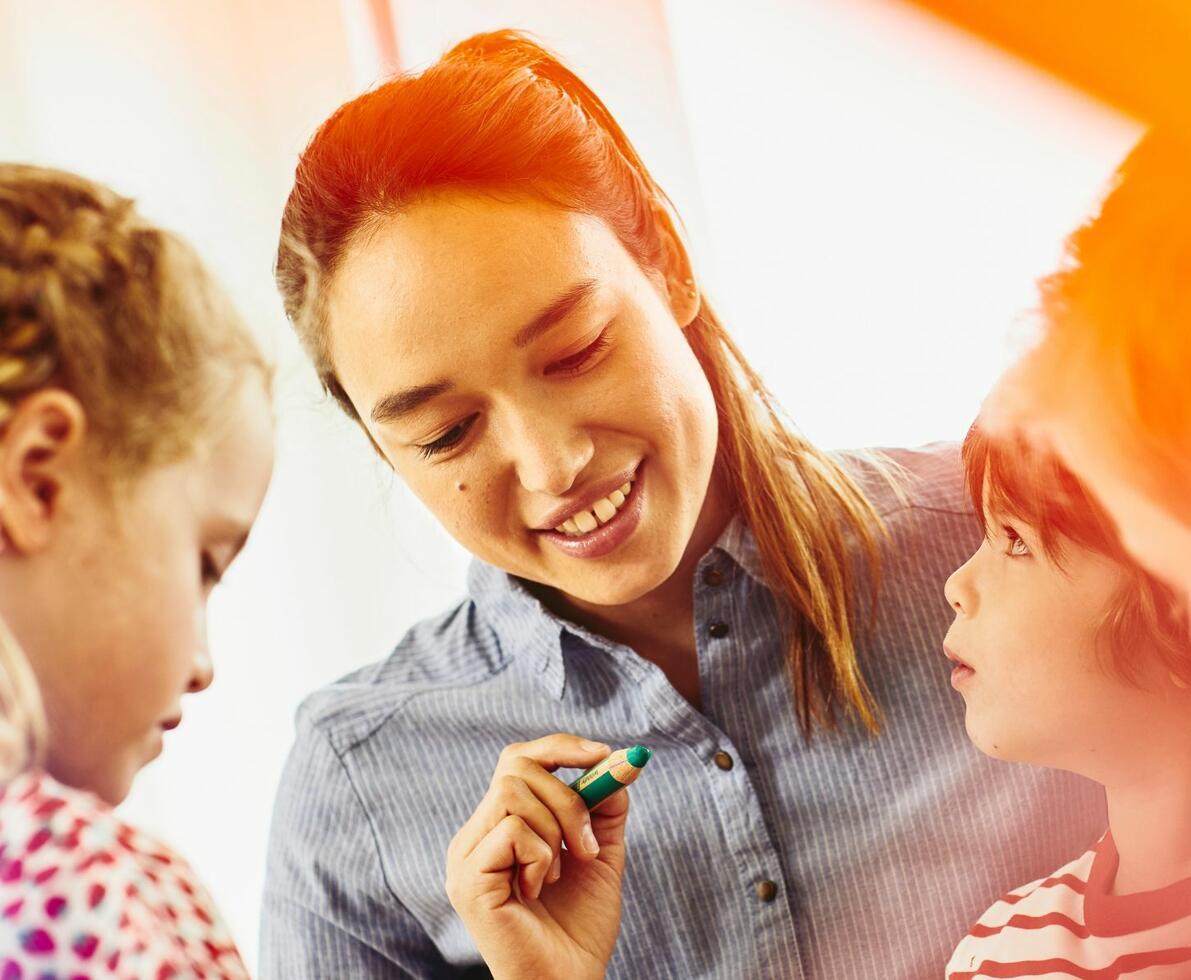 an image of a teacher smiling with children